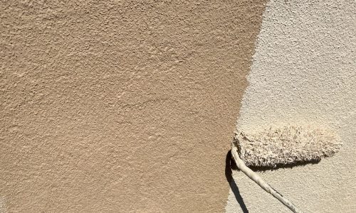 尾張旭市の住宅で中塗りを外壁行っている様子