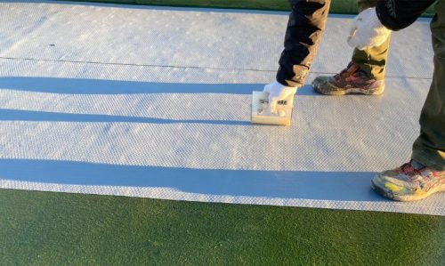 屋上防水 通気緩衝シート転圧 施工中